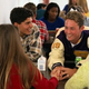 Popular kids eat lunch in the school cafeteria.